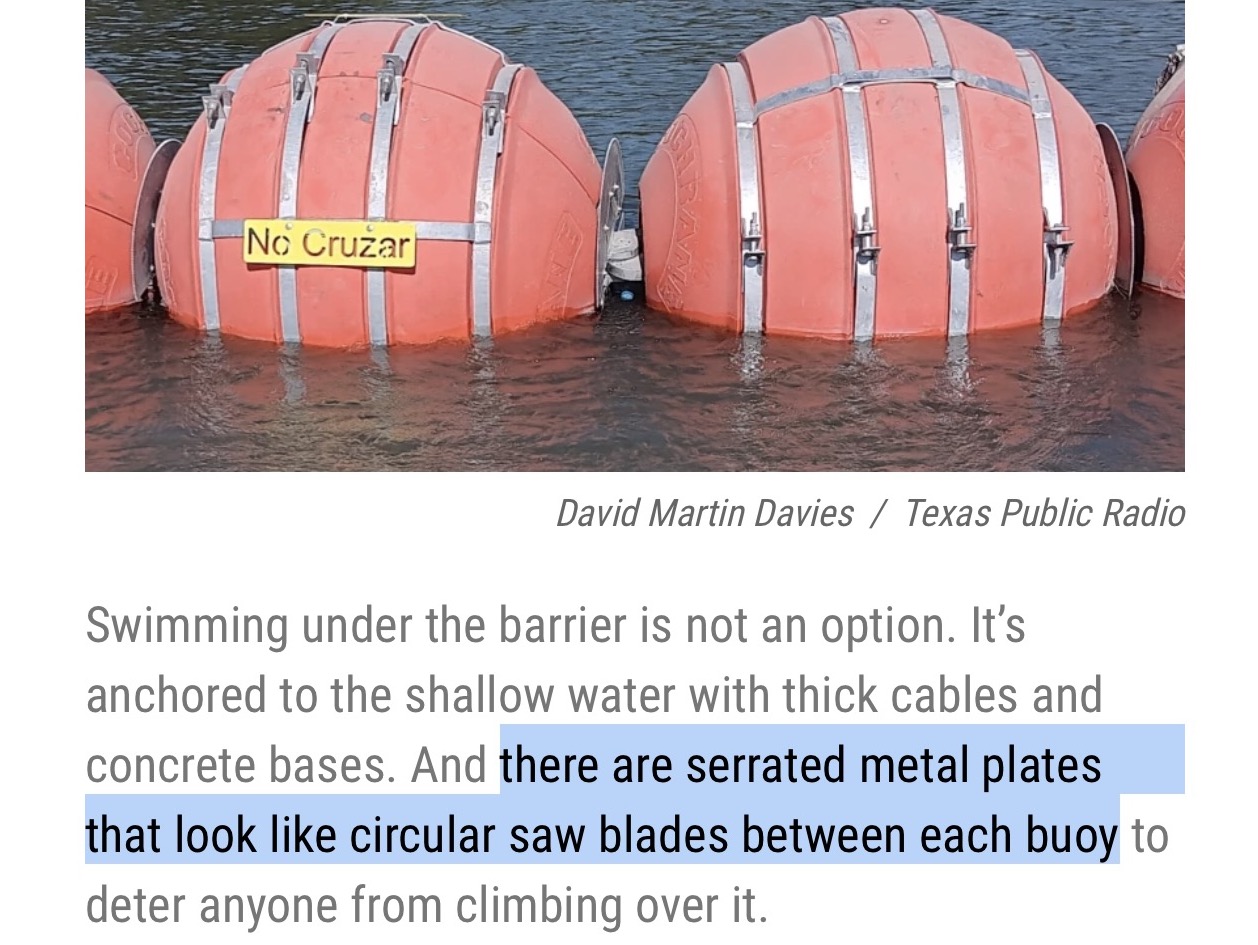 Photo caption in linked article:

"Swimming under the barrier is not an option. It’s anchored to the shallow water with thick cables and concrete bases. And there are serrated metal plates that look like circular saw blades between each buoy to deter anyone from climbing over it."